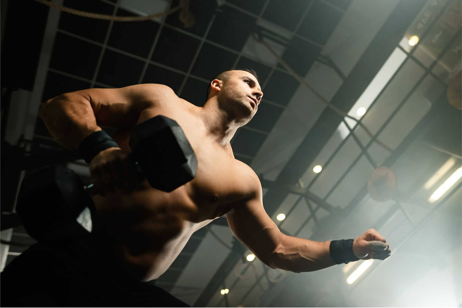 below-view-of-muscular-build-man-lifting-weights-i-TBK47J3