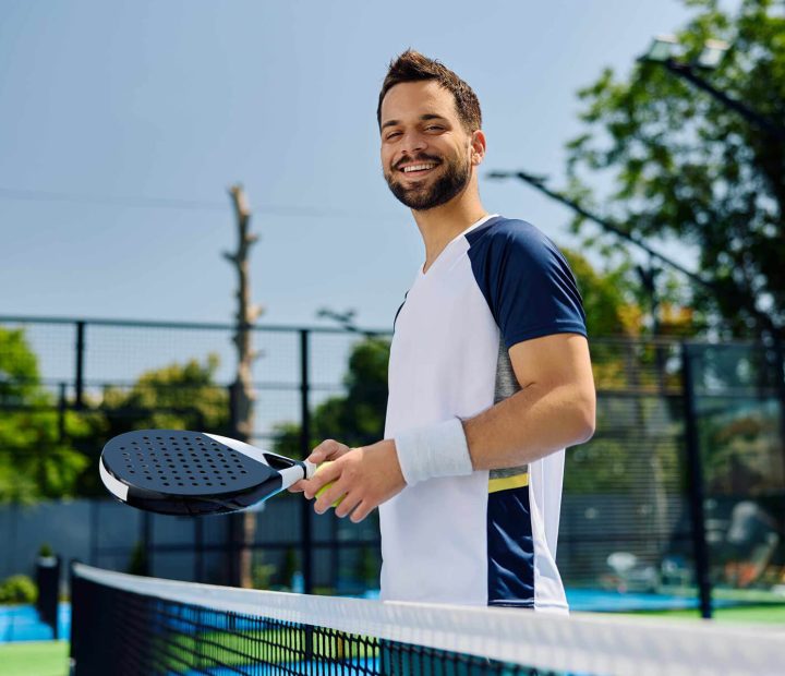 happy-paddle-tennis-player-on-the-court-looking-at-MSMY6R6